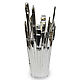 Chrome vase shaped like standing paintbrushes, bristels up