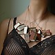 Several Black Spot Book Necklaces on mannequin 