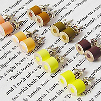 Color Pencil Stud Earrings by HuiYi Tan yellow set at an angle