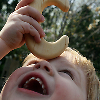 ABC Wooden Teether Rattle by Little Alouette C with boy closeup