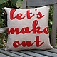 Let's Make Out Pillow by Alexandra Ferguson oatmeal and red script on chair