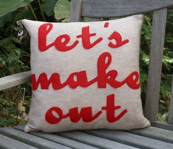 Lets_make_out_pillow_by_alexandra_ferguson_oatmeal_and_red_script_on_chair-sixhundred
