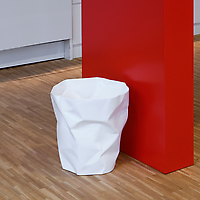 Essey Bin Bin Wastebasket beside red wall