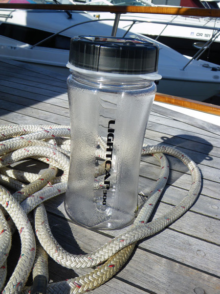 Lightcap_300_solar-powered_lantern_and_water_bottle_on_a_boat-sixhundred