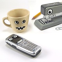 Fred Inanimate Stickers makes faces on mug, stapler and mobile phone