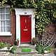 Fred Finish Line Doormat in front of red door