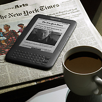Amazon_kindle_wireless_reading_device_wi-fi_graphite_with_new_york_times_and_coffee-twohundred