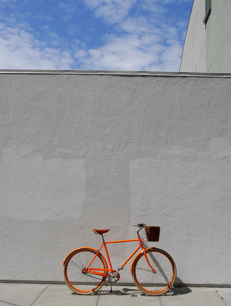 Public_orange_d3_bicycle_on_sidewalk-sixhundred