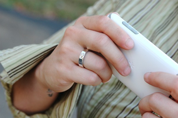 Less_than_three_heart_ring_by_metalsmitten_on_hand_with_phone-sixhundred